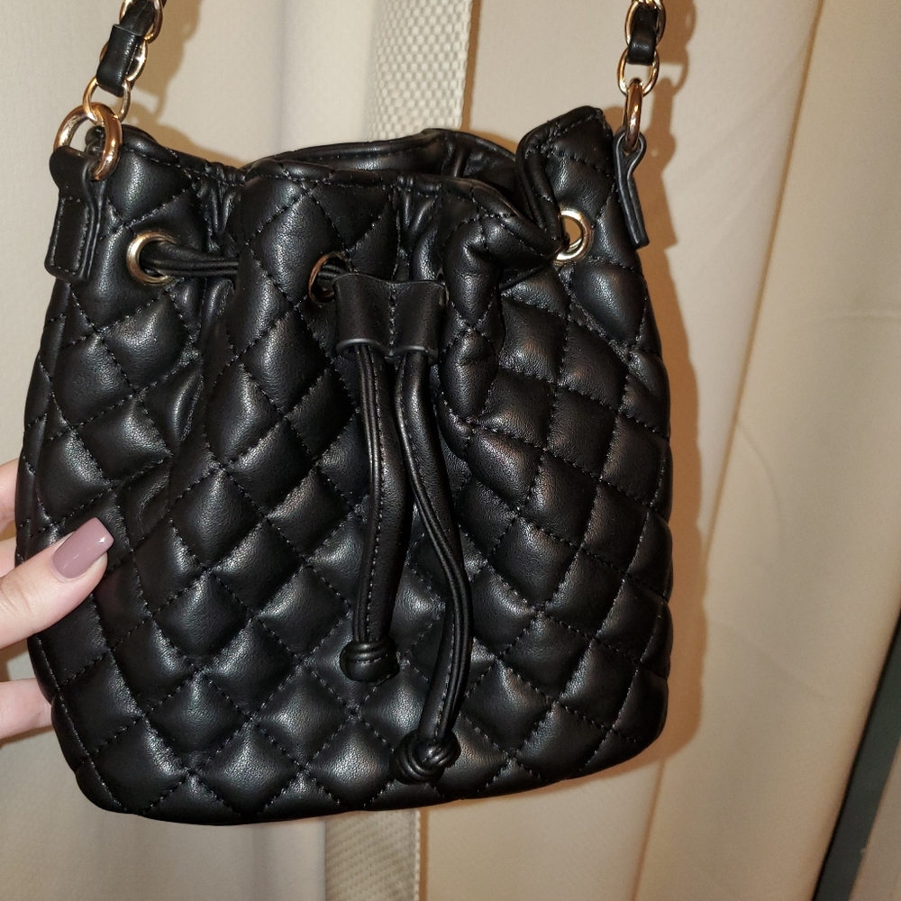Quilted faux leather pull closure bag
